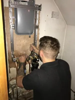 Professional engineer working on boiler installation
