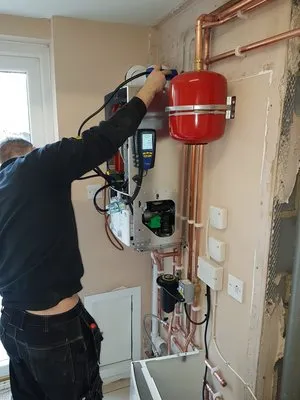 Engineer working on boiler controls and safety systems